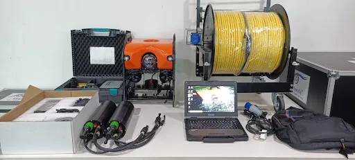 ROV tether management system setup with tether reel, control laptop, batteries, and connectors